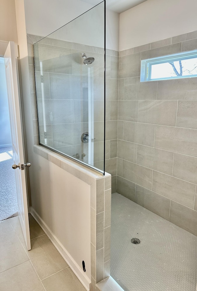 full bathroom featuring tile patterned flooring and walk in shower