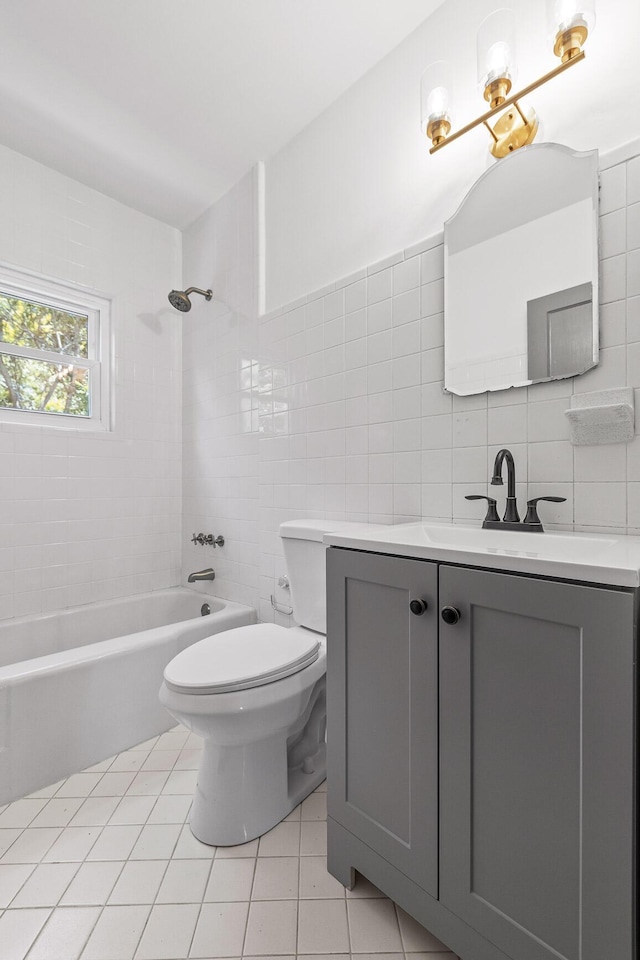 full bath featuring toilet, shower / bath combination, vanity, tile walls, and tile patterned floors