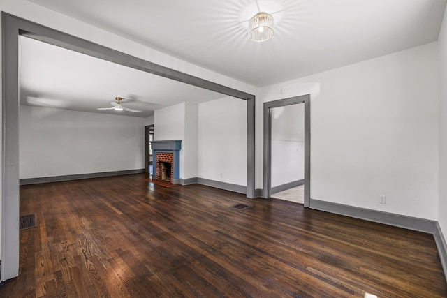 unfurnished living room featuring a fireplace, wood finished floors, and visible vents