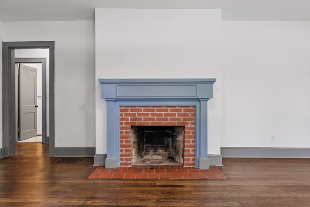 interior details featuring visible vents, a fireplace, baseboards, and wood finished floors