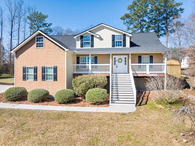 view of front facade featuring a porch, a front lawn, and stairs