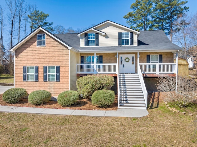 view of front of property featuring stairs, a porch, and a front yard