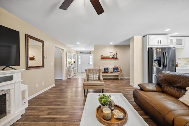 living area featuring dark wood-style floors, baseboards, a high end fireplace, and recessed lighting