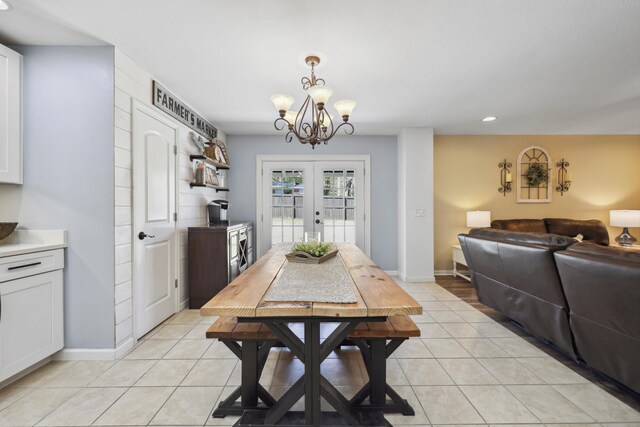 dining room with french doors, baseboards, and light tile patterned floors