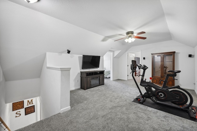 workout area with lofted ceiling, carpet floors, ceiling fan, and baseboards