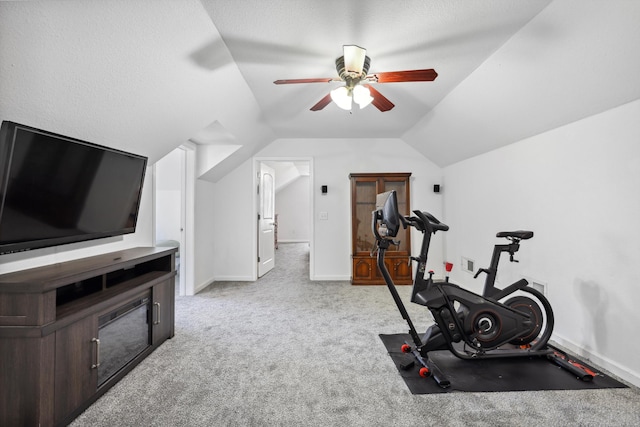 workout area featuring lofted ceiling, carpet flooring, ceiling fan, and baseboards