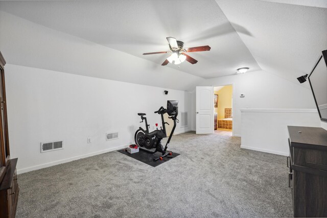 exercise area featuring vaulted ceiling, carpet flooring, and visible vents