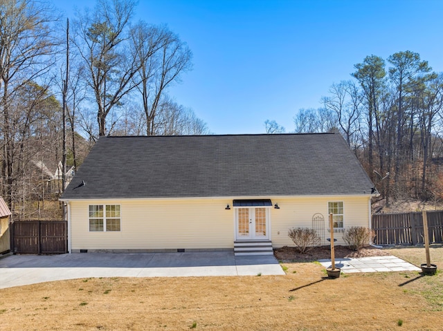 view of front facade with entry steps, a patio, fence, french doors, and a front yard