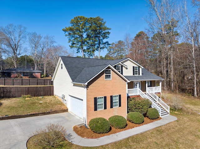 view of front of house with driveway, a garage, stairway, covered porch, and a front lawn