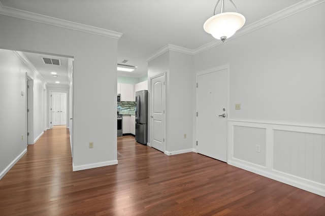 interior space featuring ornamental molding, dark wood-style flooring, and visible vents