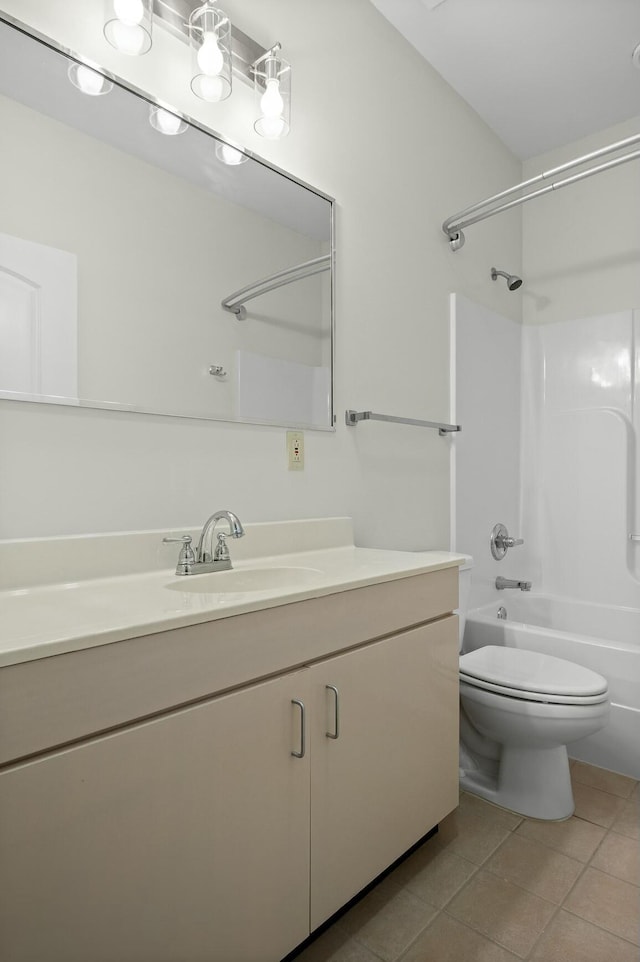 bathroom featuring toilet, tile patterned flooring, washtub / shower combination, and vanity