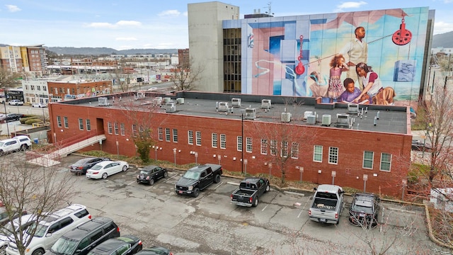 view of building exterior with uncovered parking