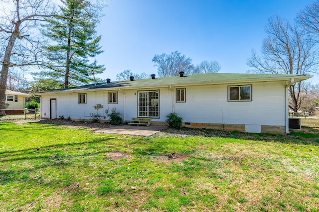 back of house featuring crawl space, entry steps, a patio, and a yard