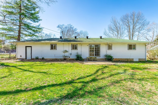 rear view of house featuring a patio, a yard, and fence