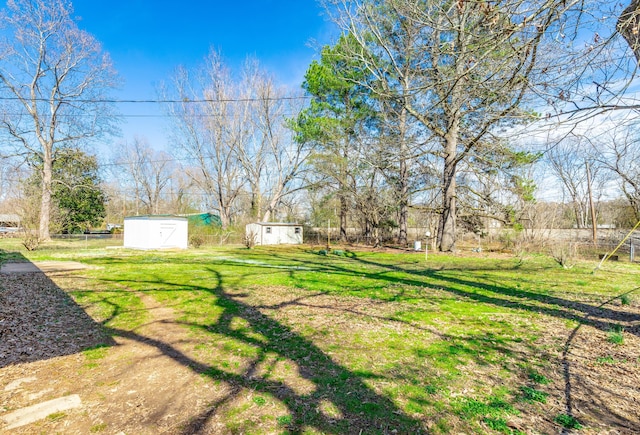 view of yard featuring a storage shed and an outdoor structure