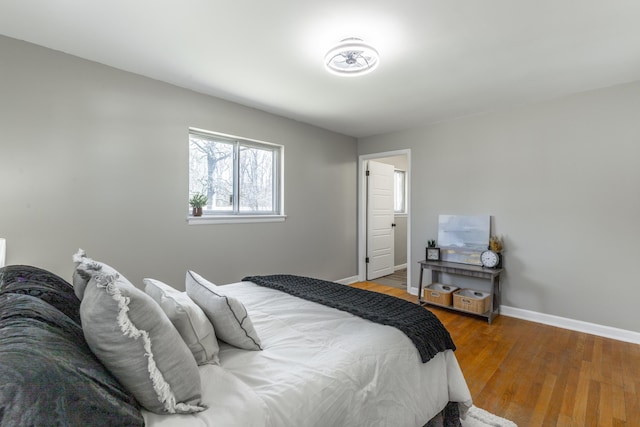 bedroom featuring wood finished floors and baseboards