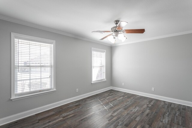 spare room featuring a ceiling fan, crown molding, baseboards, and dark wood-style flooring