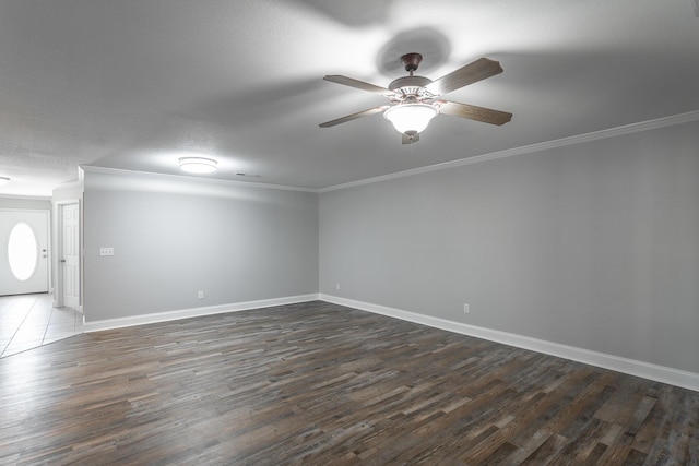 unfurnished room featuring baseboards, dark wood-type flooring, ceiling fan, and crown molding