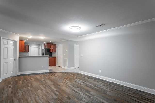 interior space featuring dark wood finished floors, visible vents, crown molding, and baseboards