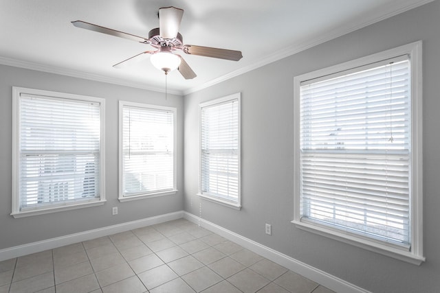 spare room with crown molding, a ceiling fan, and baseboards