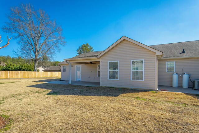 rear view of property with a patio area, a yard, ceiling fan, and fence