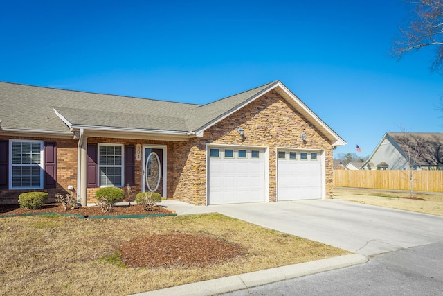 ranch-style house featuring fence, driveway, roof with shingles, an attached garage, and brick siding