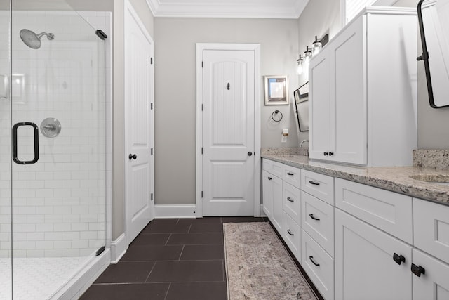 bathroom with double vanity, crown molding, a shower stall, and tile patterned floors