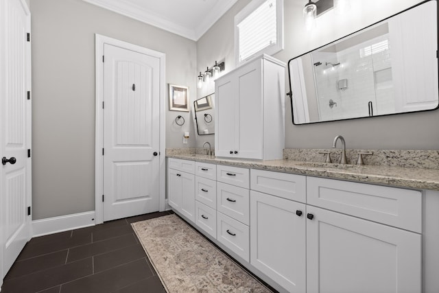 full bath with a sink, double vanity, ornamental molding, and a shower stall