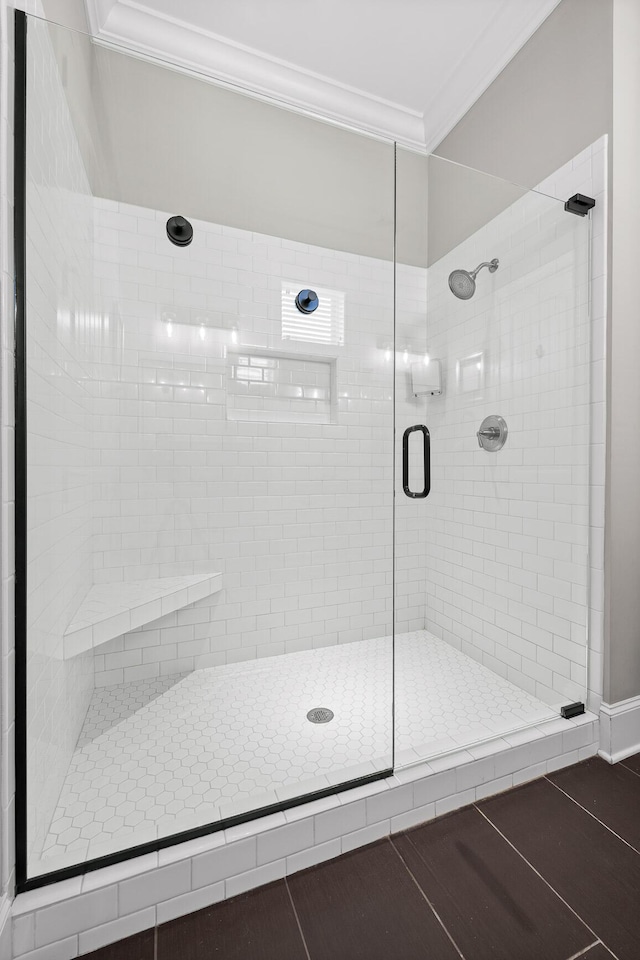 full bath with ornamental molding and a stall shower