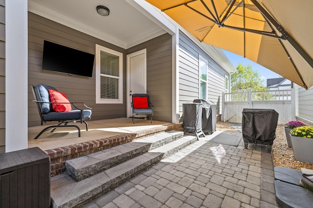 view of patio / terrace featuring grilling area and fence