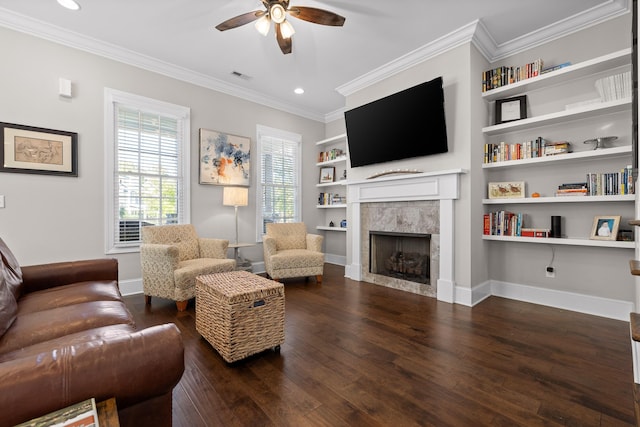 living area featuring wood-type flooring, visible vents, crown molding, and baseboards