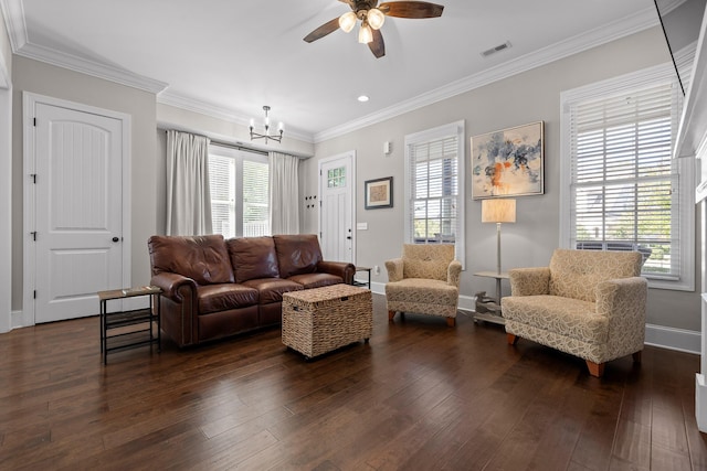 living area featuring dark wood-style flooring, a wealth of natural light, and crown molding