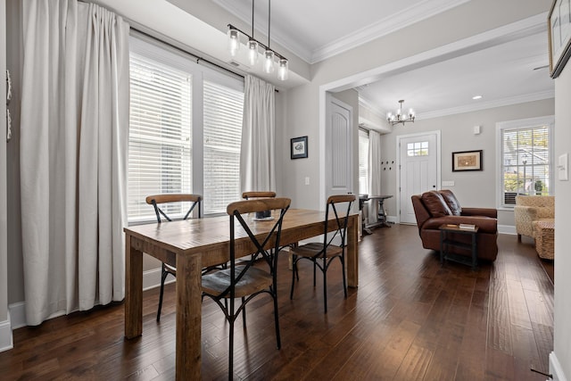 dining space featuring dark wood-style floors, a notable chandelier, ornamental molding, and baseboards