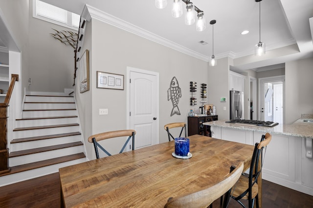 dining room with dark wood-style flooring, ornamental molding, stairway, and visible vents