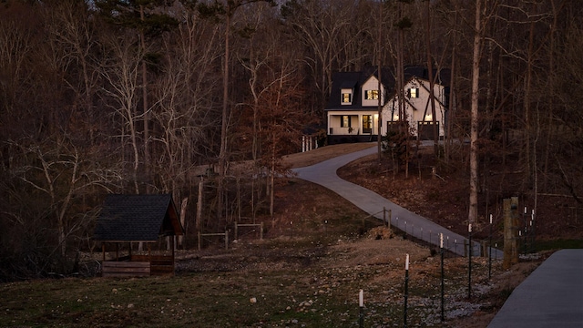 view of front of house with an outbuilding and fence