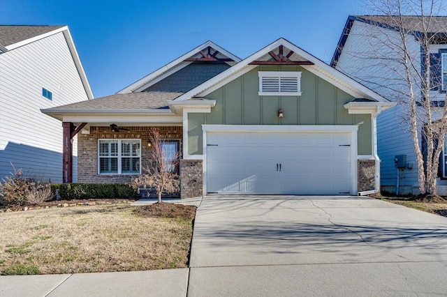 craftsman house with concrete driveway, brick siding, board and batten siding, and an attached garage