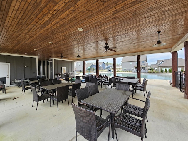 view of patio / terrace featuring a community pool, outdoor dining area, and a ceiling fan