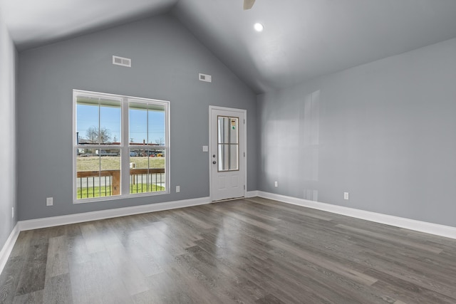 empty room featuring a ceiling fan, dark wood-style flooring, visible vents, and baseboards