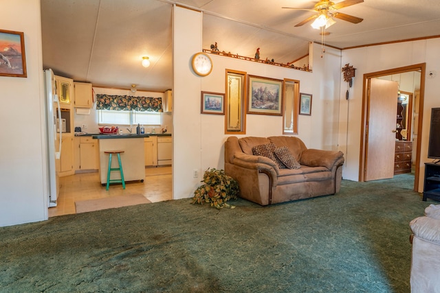 living area featuring light carpet, ceiling fan, and vaulted ceiling