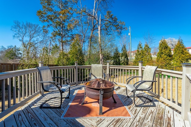 wooden deck featuring a fire pit