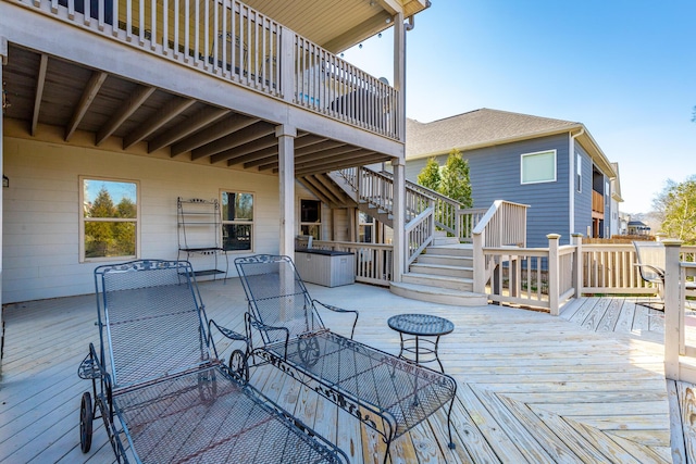 wooden deck featuring stairway and outdoor dining space