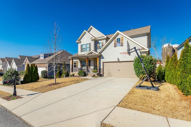 view of front of property featuring an attached garage, a porch, and driveway