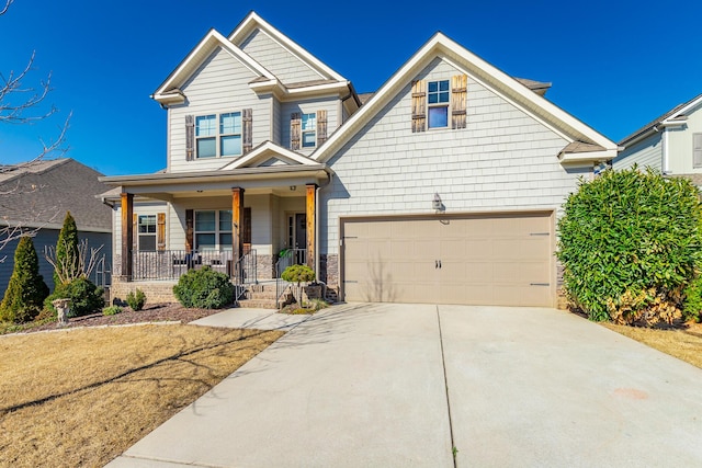 craftsman-style house featuring a porch, concrete driveway, and a garage