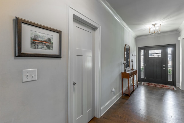 entryway with baseboards, an inviting chandelier, ornamental molding, and dark wood finished floors