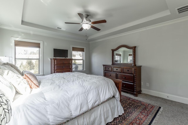 bedroom featuring a raised ceiling and visible vents