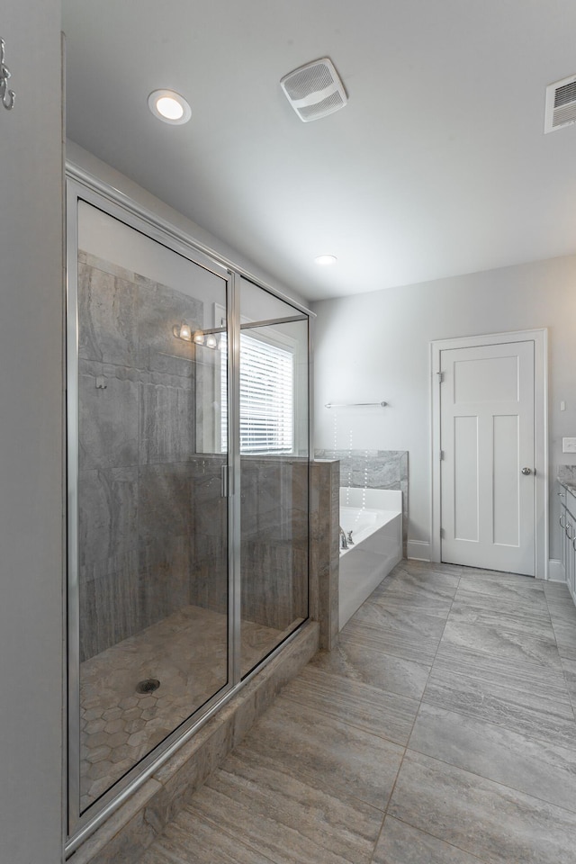 bathroom featuring recessed lighting, visible vents, a garden tub, and a stall shower