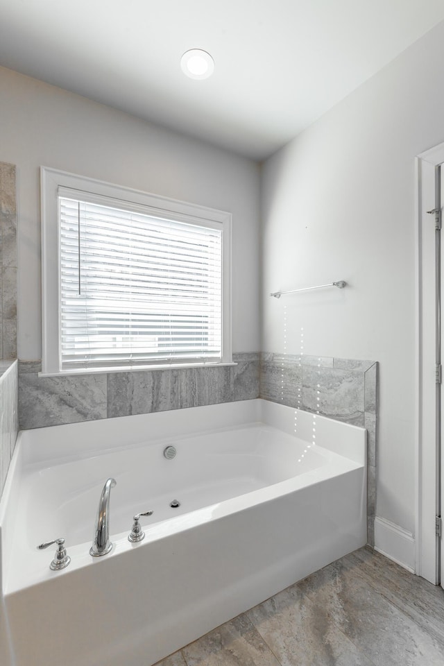 full bath with a wealth of natural light and a garden tub