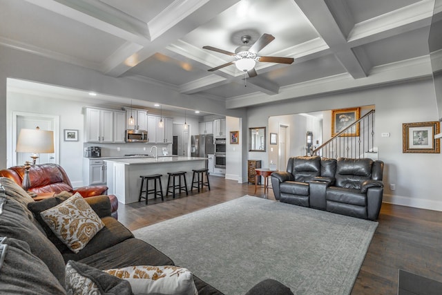 living area featuring dark wood-type flooring, baseboards, and beam ceiling