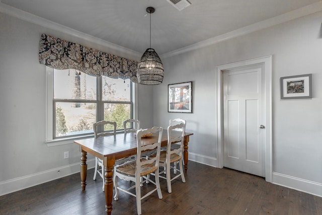 dining room with baseboards, dark wood finished floors, and ornamental molding