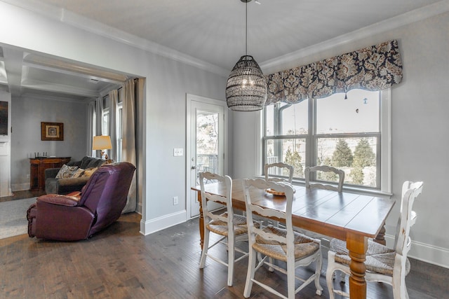 dining area featuring baseboards, dark wood-type flooring, a chandelier, and crown molding